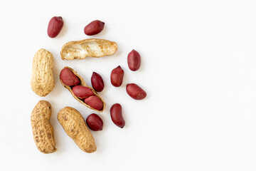 Dried peanuts in peel close-up isolated on white background.