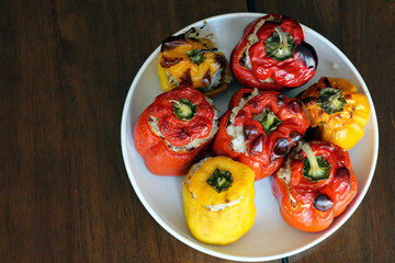 Grilled peppers stuffed with minced meat on a white plate