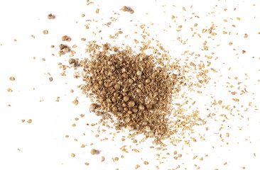 Coriander ground pile and seeds isolated on white background, top view