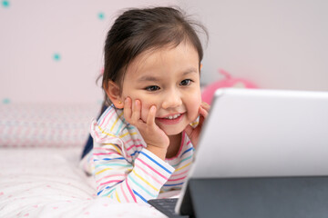 Happy little girl using digital devise.