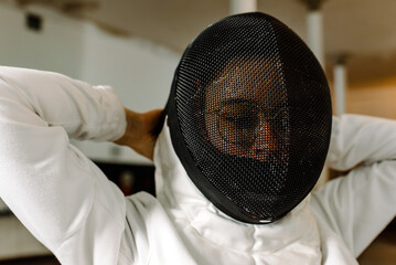 Young Girl Adjusting Fencing Suit