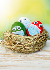 Easter colored eggs as the color of the Italian flag - green, white, red - in face mask and house quarantine, Lockdown concept of coronavirus covid 19 Pandemic. Stay Home at Easter holiday