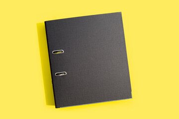 Office folder on yellow background.