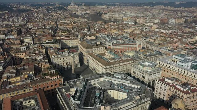 Aerial view of downtown Rome, Italy. City center with Italian government buildings in Piazza Colonna seen from drone flying in sky and Saint Peter's Basilica in Vatican City in background