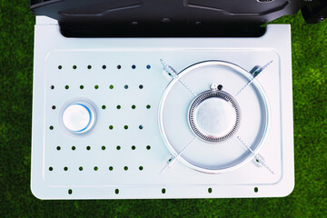 Detail of the gas burner of a kitchen, clean and new in steel.