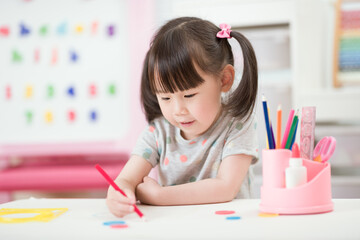 young girl practice drawing different shapes  for homeschooling