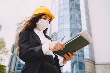 Female architect with construction site on the background