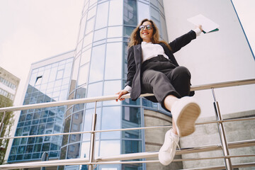 Businesswoman standing outdoors in city office building background