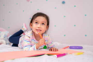 Girl child looking up thinking.