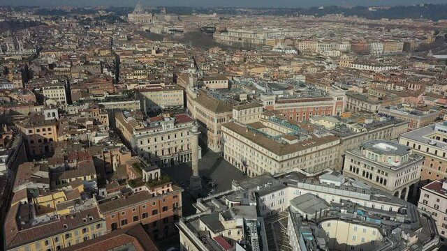 Aerial view of downtown Rome, Italy. City center with Italian government buildings in Piazza Colonna seen from drone flying in sky and Saint Peter's Basilica in Vatican City in background