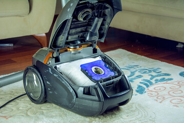 Replacing the dust bag of a pair of handheld electric vacuum cleaners