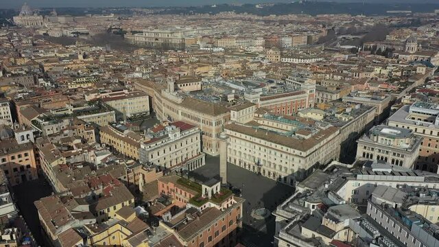 Aerial view of downtown Rome, Italy. City center with Italian government buildings in Piazza Colonna seen from drone flying in sky and Saint Peter's Basilica in Vatican City in background