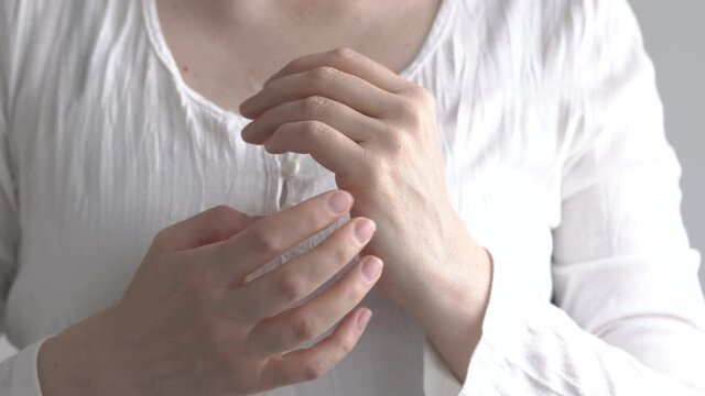 Woman practicing EFT - tapping on the side of the hand