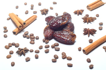 Dates, cinnamon, anise and coffee beans on a white background. Dried fruits. Dried dates lie next to each other