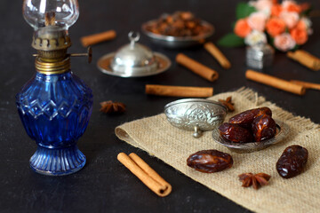 Dried dates on a wooden table in silver dishes close-up. Composition of dried dates in ramadan dish on wooden table. 