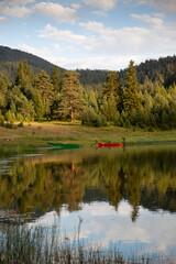 Fototapeta na wymiar Mountain lake landscape with forest reflecting in the water