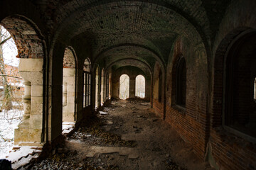 Fototapeta na wymiar Dark corridor of old ancient abandoned red brick ruined historical building
