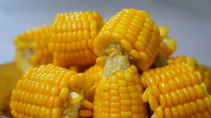 Pieces of boiled corn on a yellow glass plate