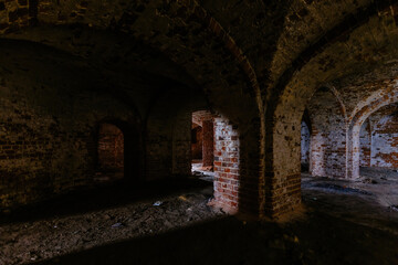 Fototapeta na wymiar Dark and creepy vaulted red brick dungeon