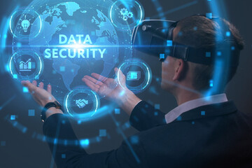 Obraz premium Business, Technology, Internet and network concept. Young businessman working on a virtual screen of the future and sees the inscription: Data security