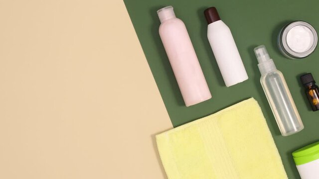 Skin care wellness spa and beauty products move up down on beige and dark green background. Stop motion flay lay