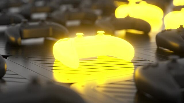 Black joysticks on a black textured surface. Yellow glowing objects on the background. Depth of field. Gamepads on glossy table background. Close up. Gamer concept. 3d loop animation 4K
