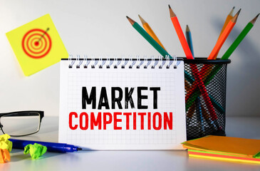 market competition text written on notebook with pencils and office tools