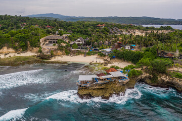 Dramatic aerial view of the .Mahana Point.on the rugged coast of the Ceningan island in Bali...