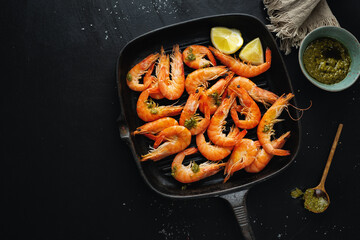 Shrimps with spices on pan