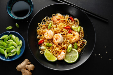 Asian noodles on plate on dark background