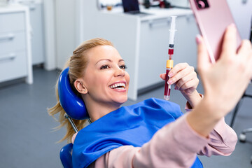 Platelet rich plasma ( PRP) therapy process. Woman is taking selfie photo.