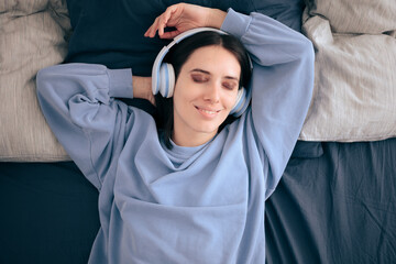 Relaxed Woman Wearing Headphones Lying in Bed