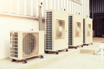 Condenser unit or compressor outside industrial plant building. Unit of central air conditioner...
