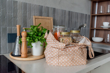Cotton bag with groceries the kitchen table. Conscious consumption.
