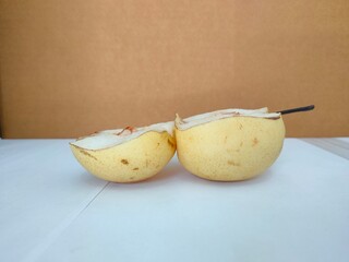 Pears fruit cut in half on a white background. 