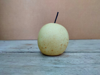 Whole pear or pyrus fruit on wooden surface