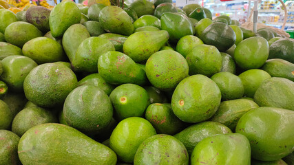 Avocados at foodmart market. Healthy food background. Avocado fruit at farmers market.