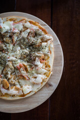 Delicious fresh pizza on wooden background   
