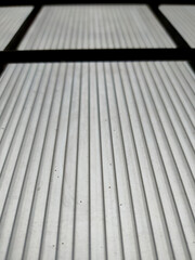 Dim light from the window of the bed transparent with iron bars.