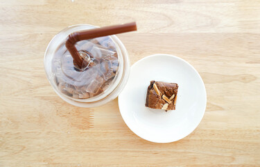 Almond brownies with some cold drinks on a wooden table
