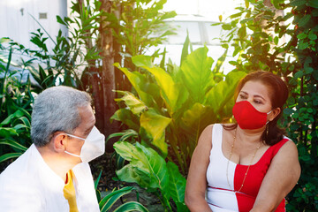 Obraz premium Older couple with protective mask talking in park