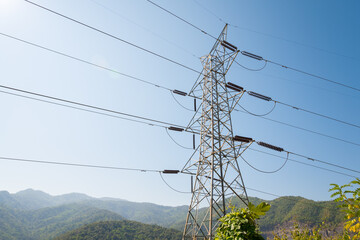 Electricity post high power from big hydro water dam on the mountain hill with blue sky background...