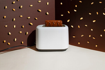 Chocolate in a toaster, peanuts falling on top. Fun creative concept
