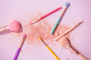 Make up brushes with powder on white background