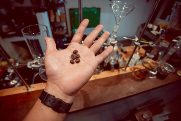 Coffee beans on the hands of a lab researcher For testing the quality of coffee beans used in the beverage industry.