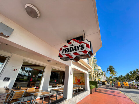 TGI Fridays sign is mounted above the entrance to the restaurant located at Art Deco district.