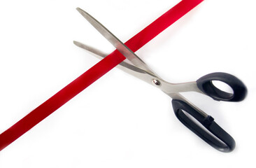 Scissors cutting red ribbon