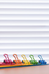 Vibrant Coloured Paperclips on File Folders, White Background, Copy Space