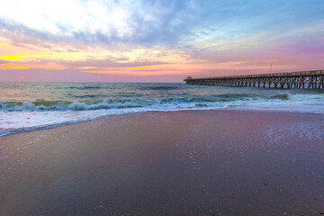 Myrtle Beach Sunrise Landscape. Sunrise on a wide sandy beach with fishing pier on the coast of the...