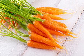 Fresh and sweet carrot on a grey wooden table